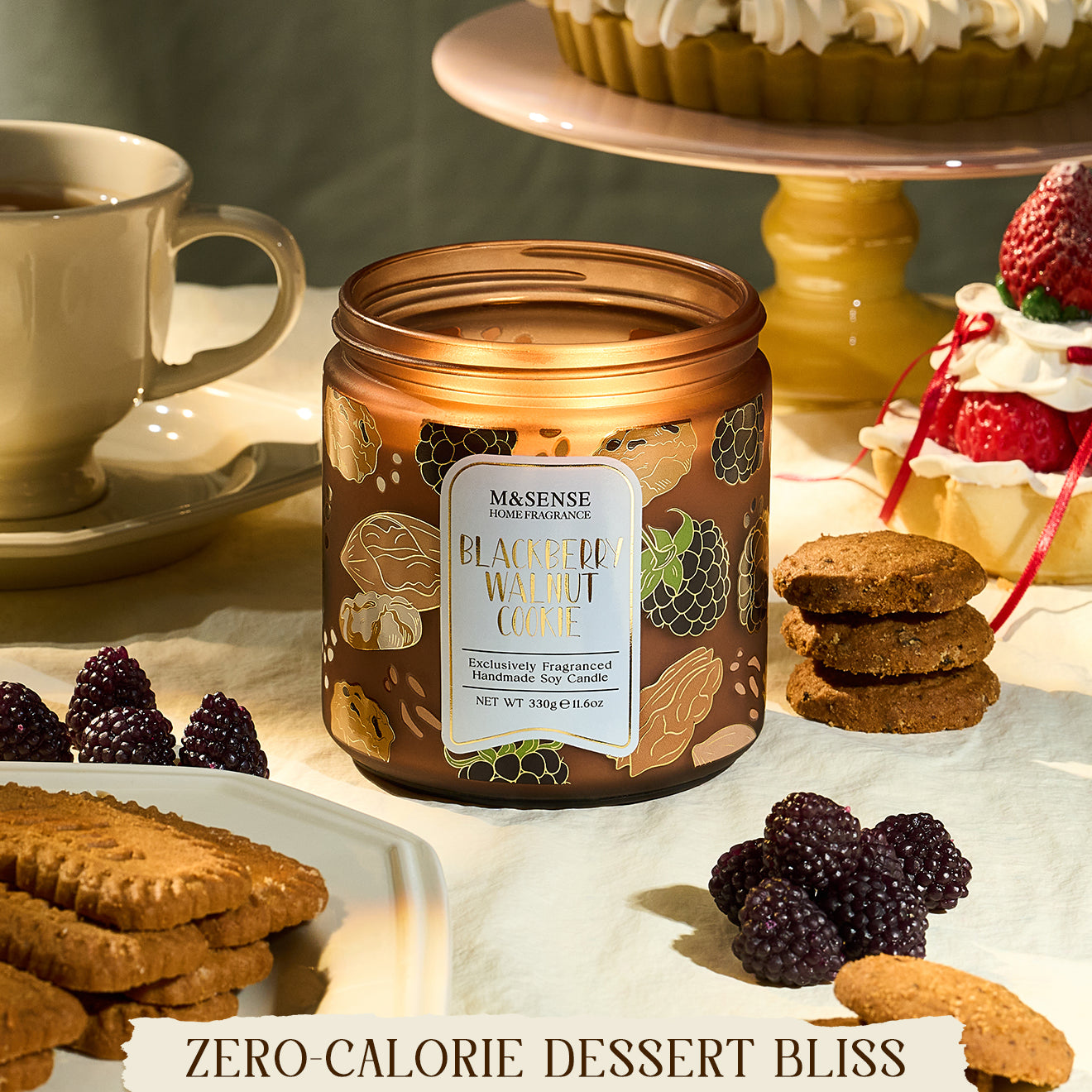 Candle jar labeled 'Blackberry White Chocolate' on a table with desserts and cookies.