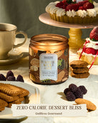 Candle jar labeled 'Blackberry White Chocolate' on a table with desserts and cookies.