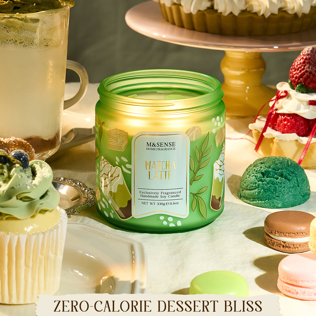 Green candle labeled 'Matcha Latte' on a table with desserts