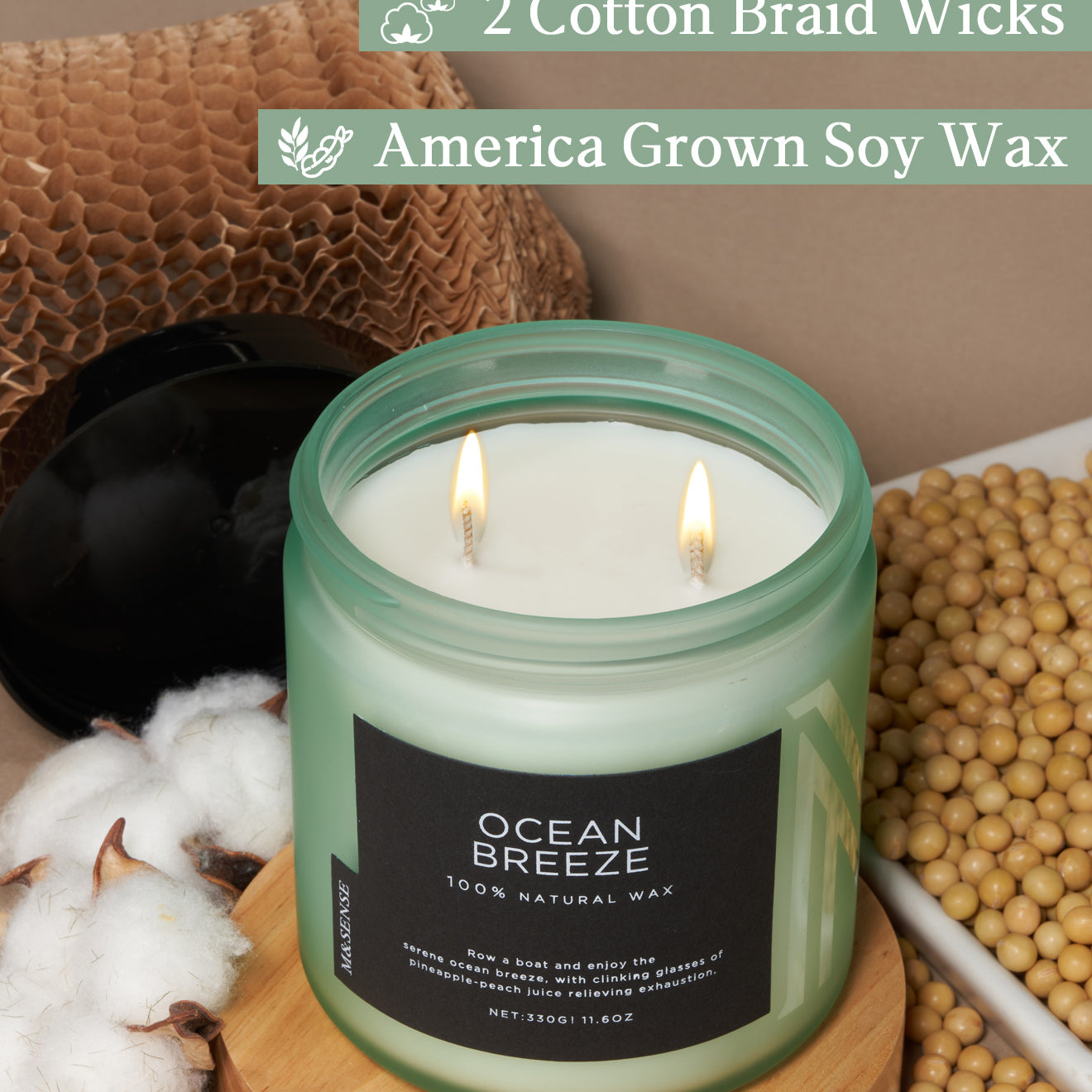 Candle with 'Ocean Breeze' label on a wooden surface with cotton and soybeans, featuring text about wicks and wax.