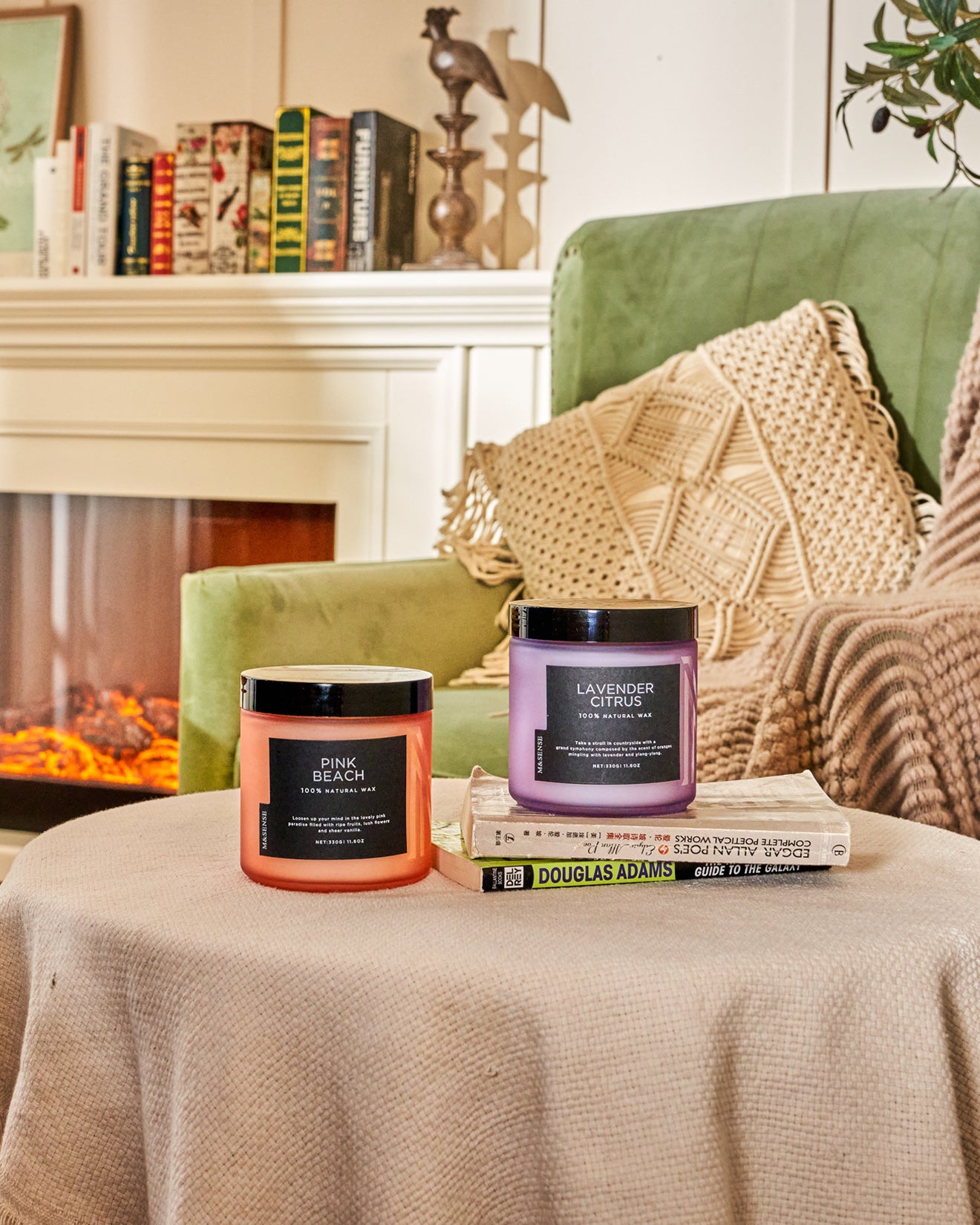 2 home decor frosted glass jar candles on wooden round small table.