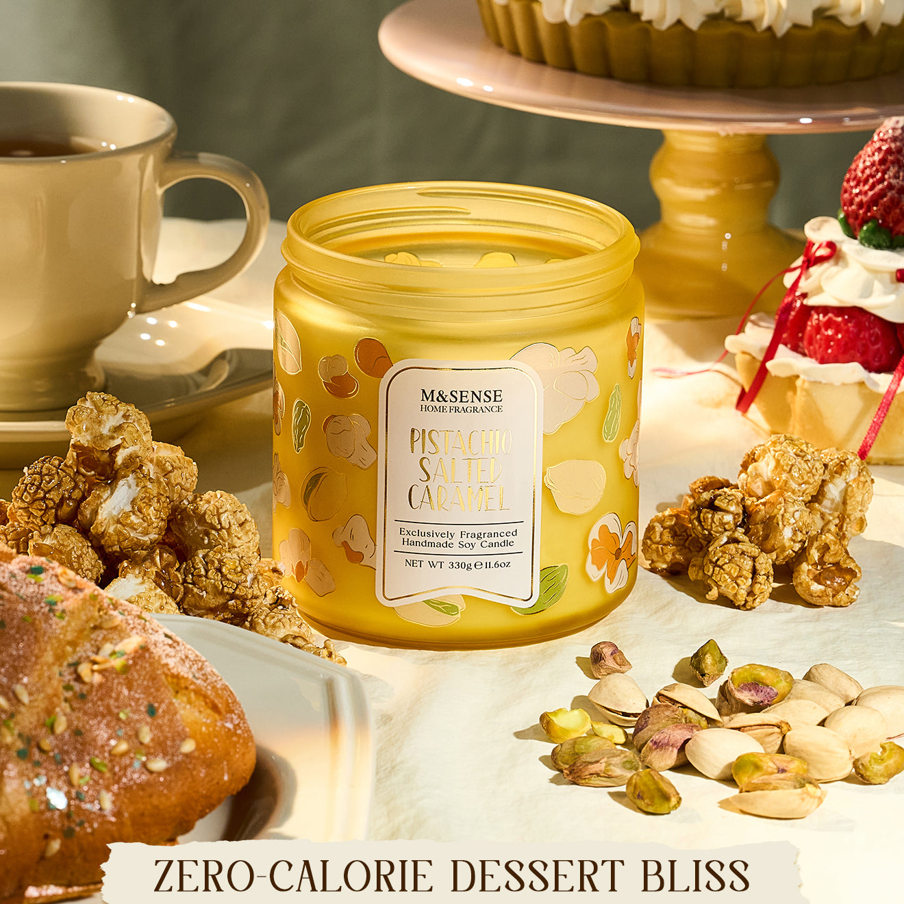 Yellow candle jar with a label on a table with desserts and snacks