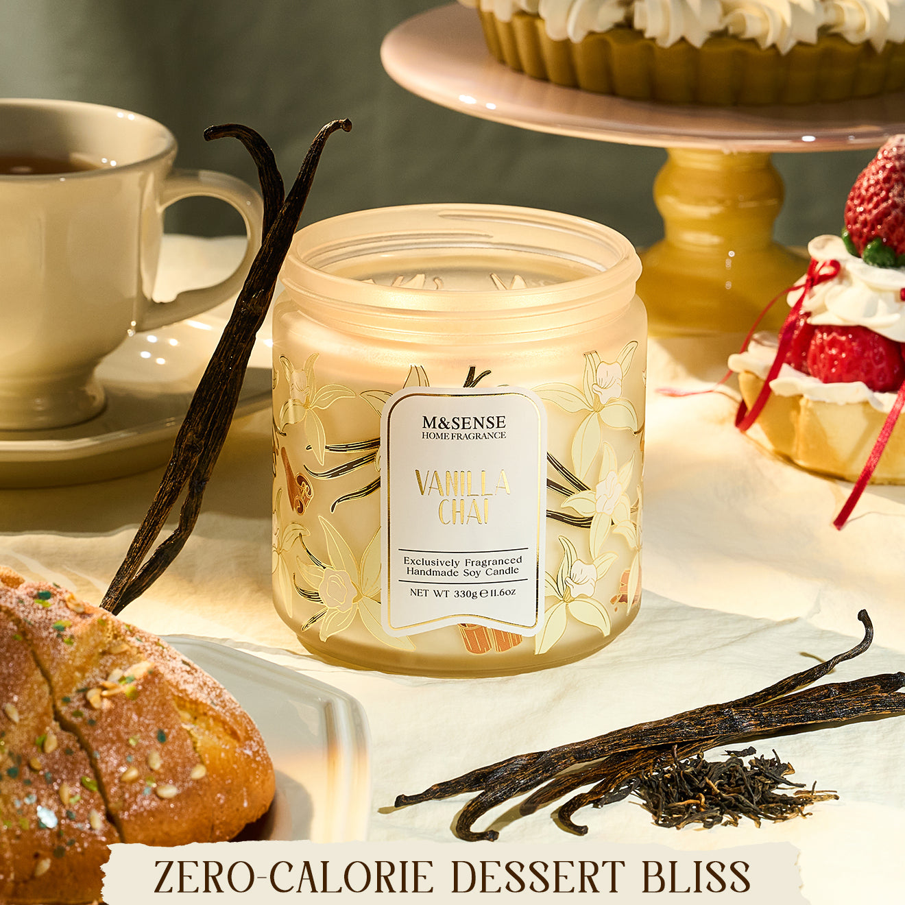 Másónse vanilla bean candle on a table with desserts and vanilla pods.