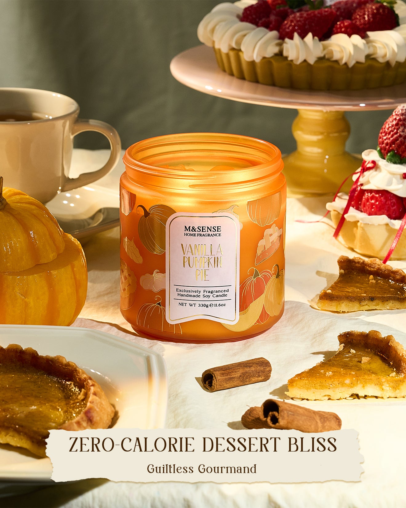 Orange candle labeled 'Vanilla Pumpkin Pie' on a table with desserts and a cup.