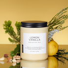 Candle labeled 'Lemon Vanilla' with natural elements on a reflective surface and yellow background