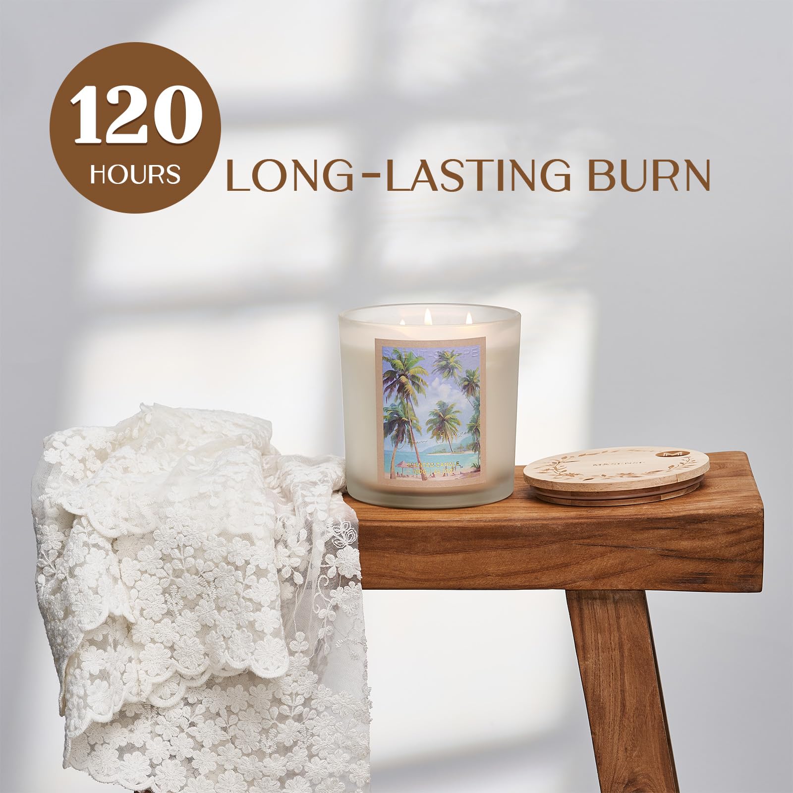 Candle with scenic design on a wooden table with decorative rock and coaster, labeled '120 Hours Long-Lasting Burn'.