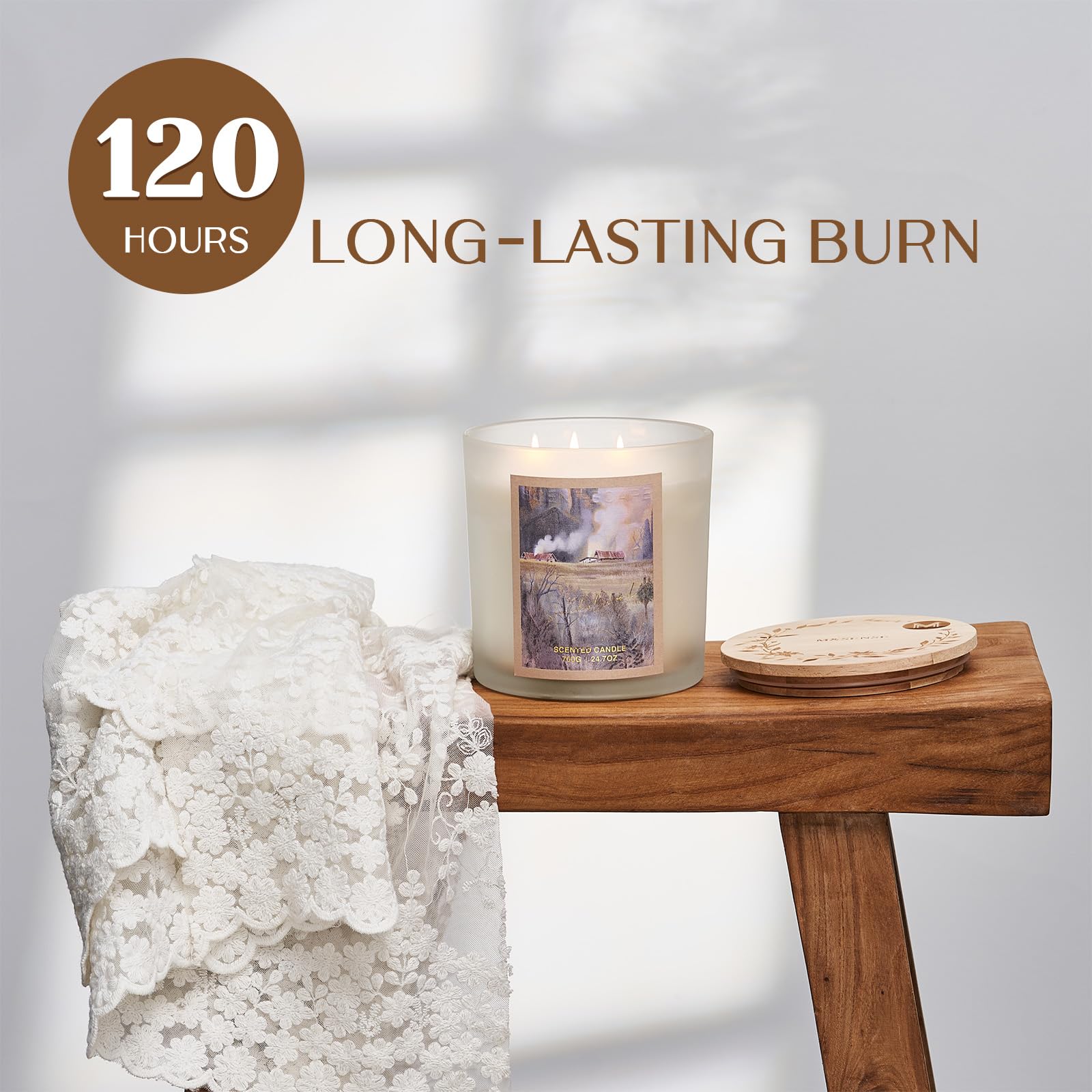 Candle with a scenic design on a wooden table next to a crystal, with text indicating '120 hours long-lasting burn'.