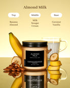 Candle labeled 'Almond Milk' with banana, almond, and coffee mug imagery on a beige background