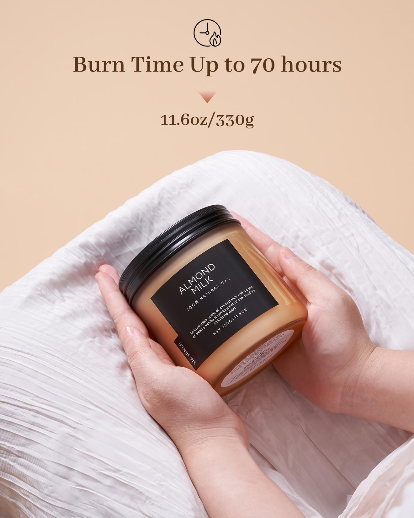 Candle labeled 'Almond Milk' held by a hand with text indicating burn time and weight.