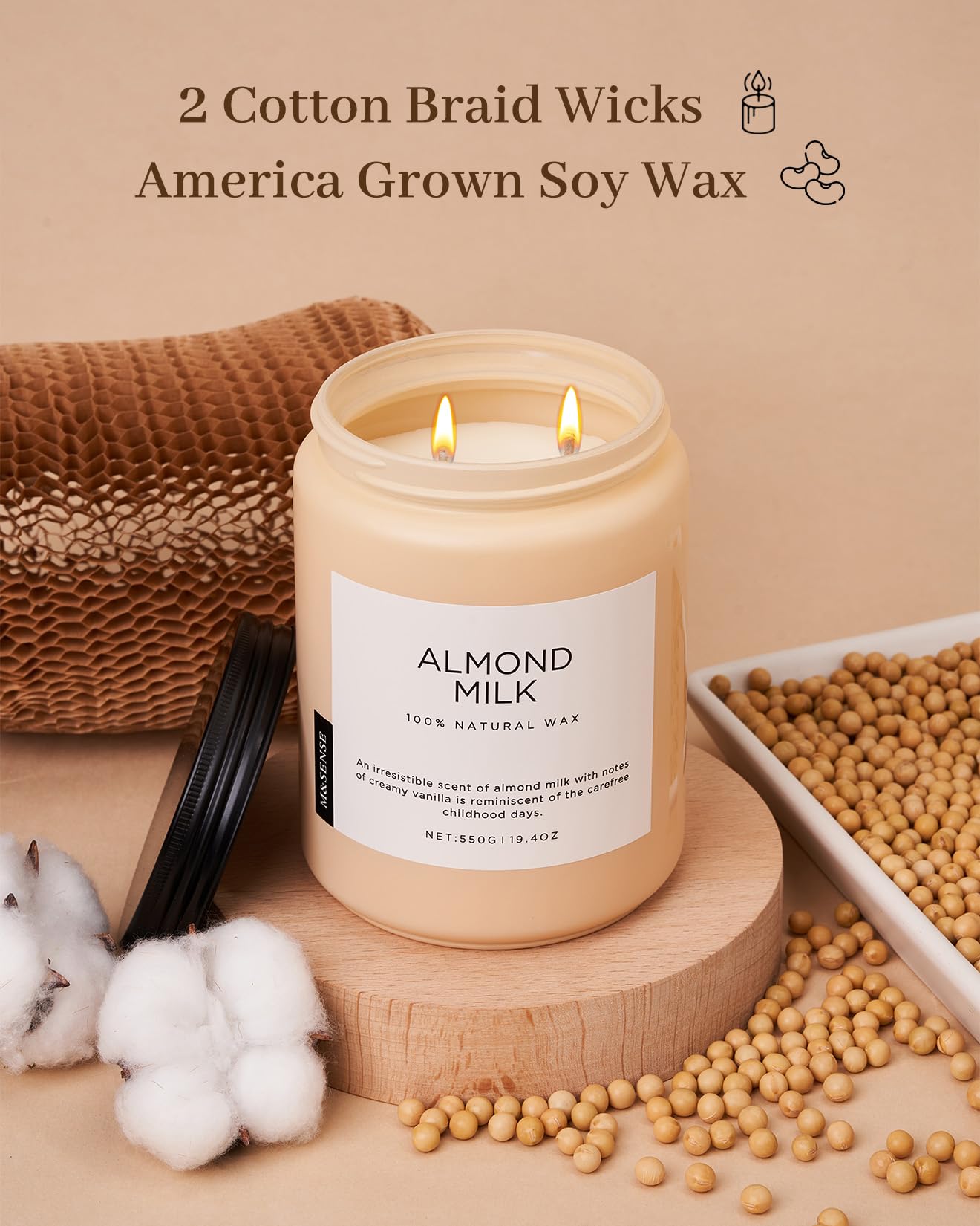 Candle labeled 'Almond Milk' with cotton braid wicks and soy wax on a beige background