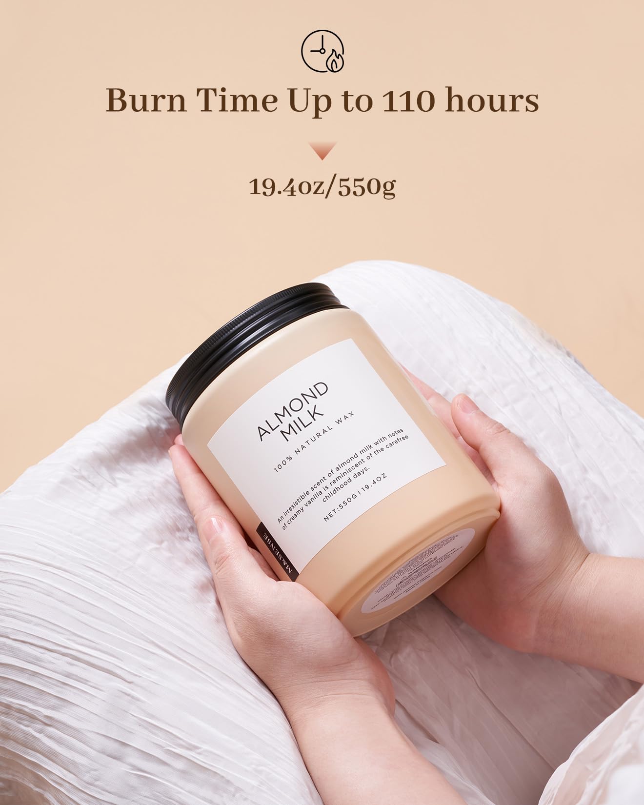 Candle labeled 'Almond Milk' held by a hand with text indicating burn time and weight on a beige background