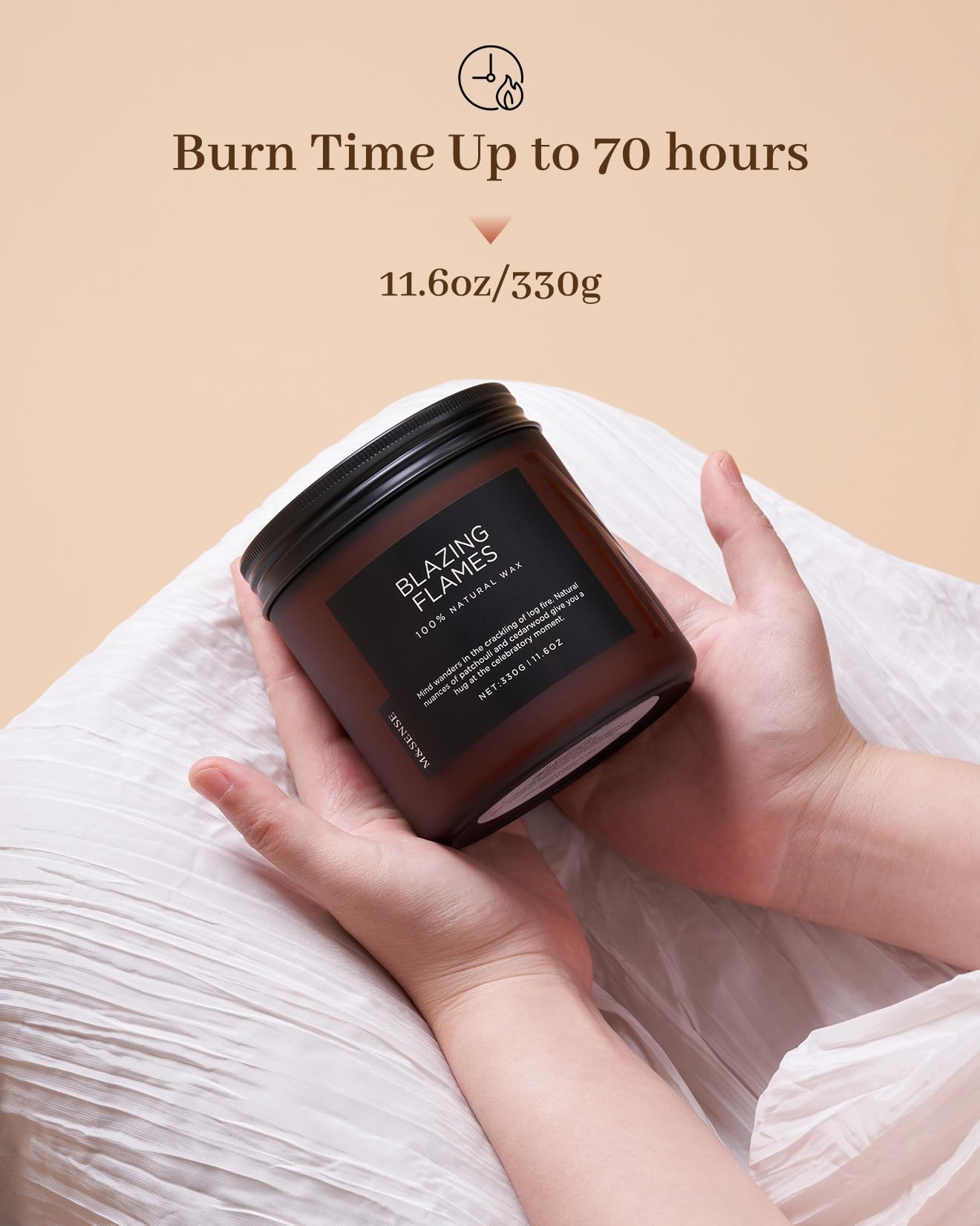 Hand holding a candle labeled 'Blazing Flames' with text about burn time and weight on a beige background.