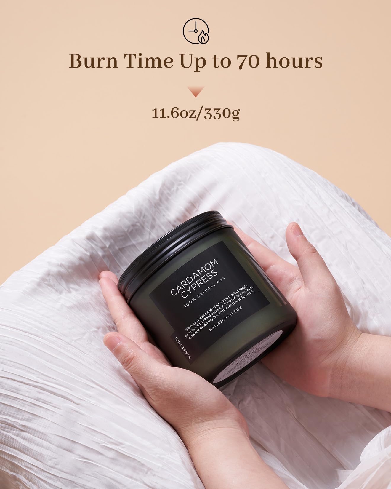 Hand holding a candle labeled 'Cinnamon Cypress' with text about burn time and weight on a beige background.