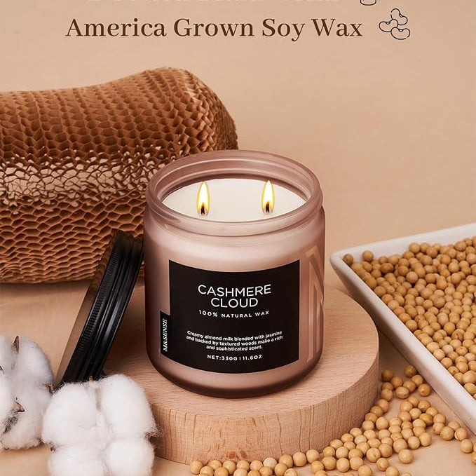 Candle with 'Cashmere Cloud' label on a wooden surface with cotton and soybeans, featuring text about wicks and wax.