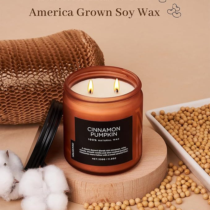 Candle with cotton braid wicks and 'Cinnamon Pumpkin' label on a beige background