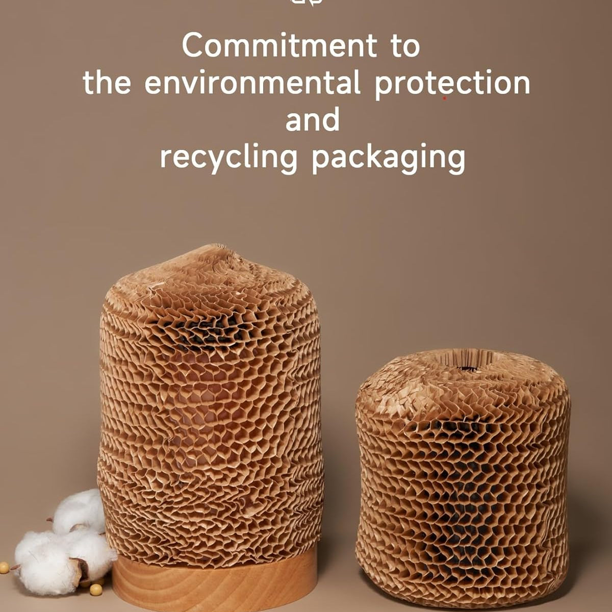Two cardboard packaging rolls with cotton fibers on a brown background, emphasizing environmental protection and recycling.