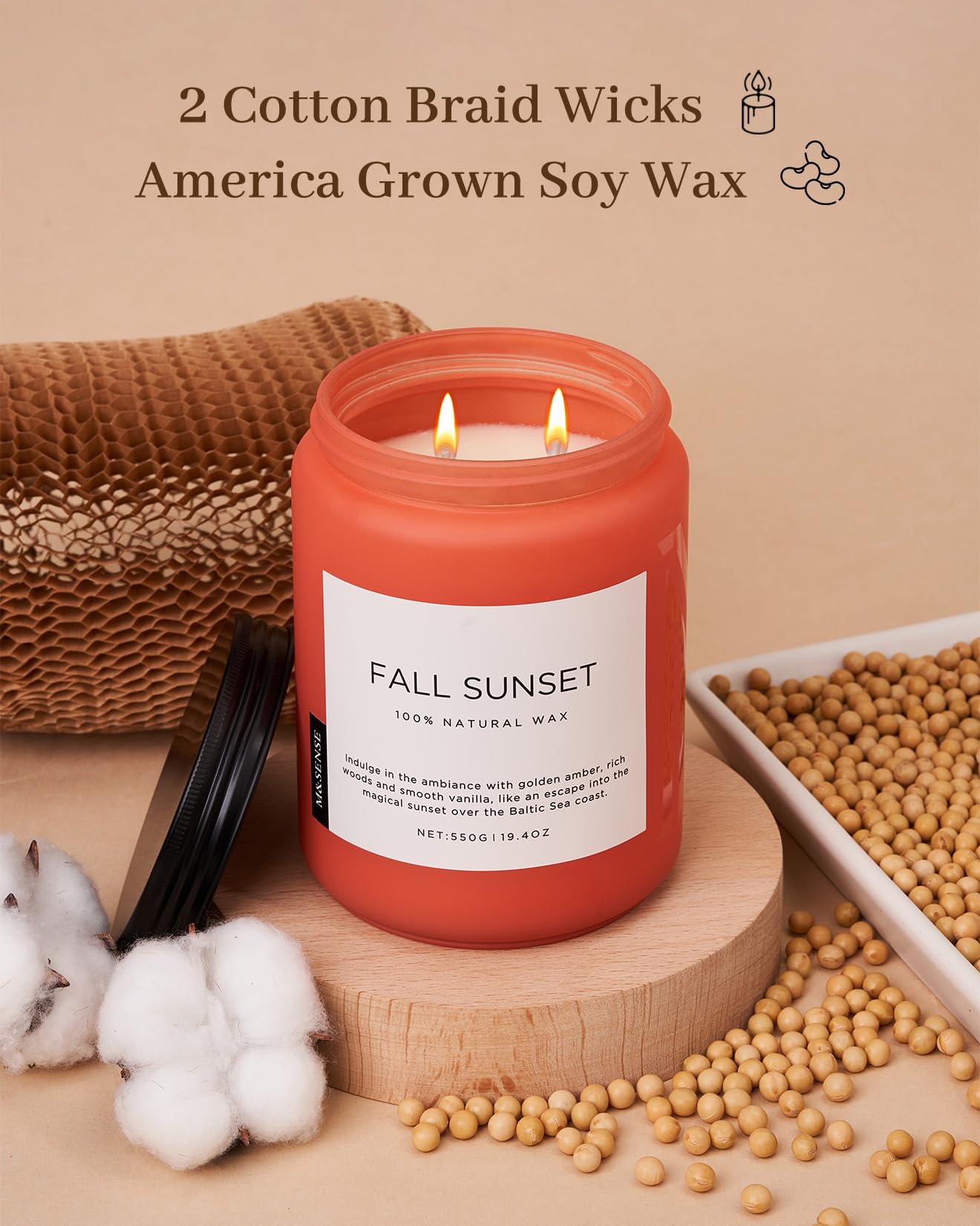 Red candle labeled 'Fall Sunset' with cotton braid wicks and soy wax on a beige background