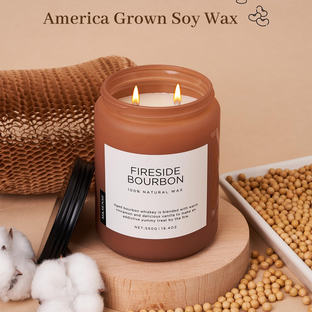 Candle labeled 'Fireside Bourbon' with soy wax and cotton braid wicks on a wooden surface.
