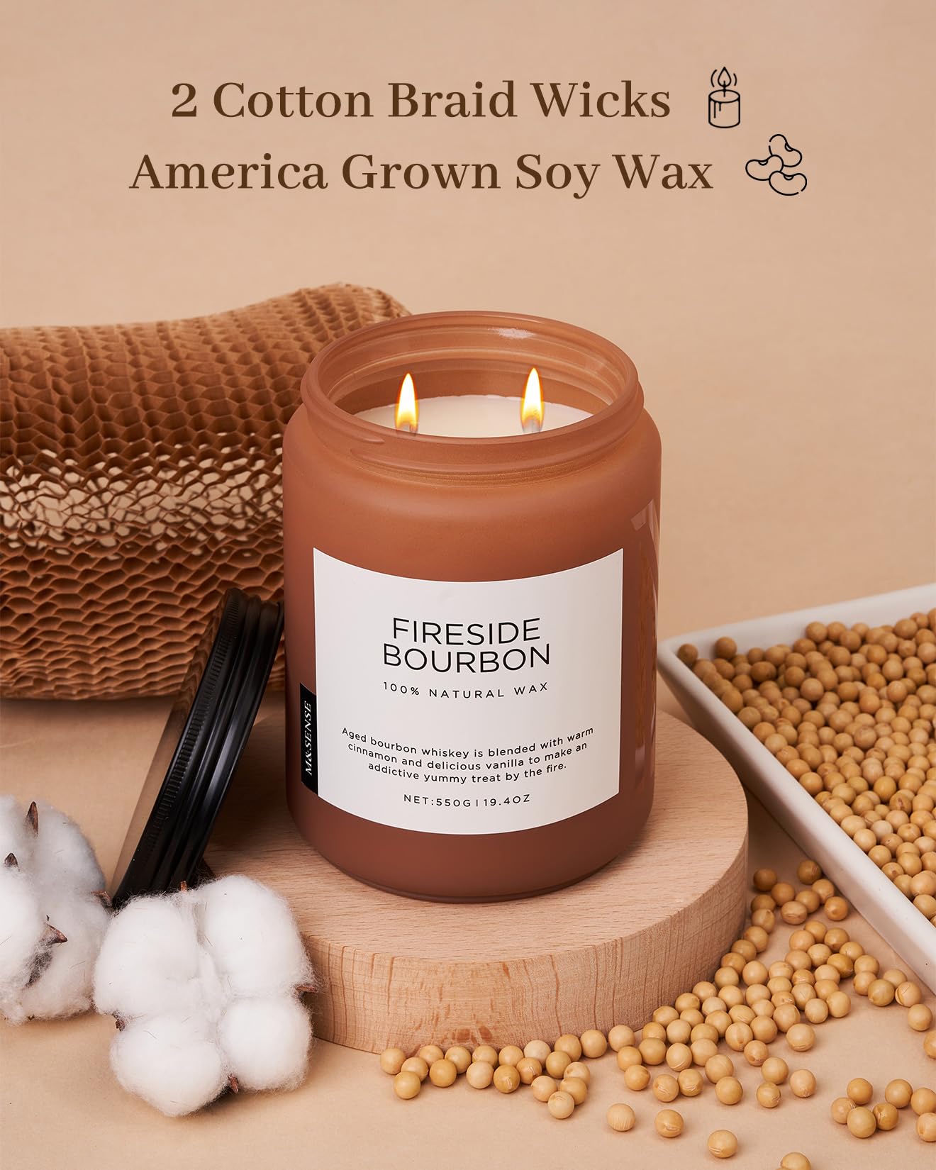 Candle labeled 'Fireside Bourbon' with soy wax and cotton braid wicks on a wooden surface.