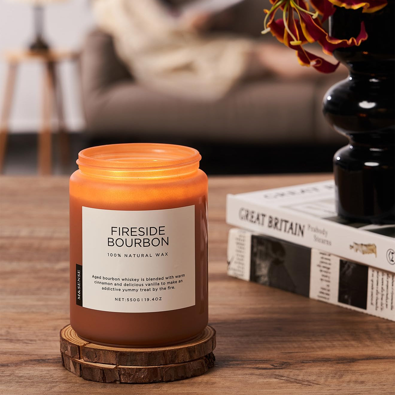 Fireside Bourbon candle on a wooden coaster with a cozy living room background