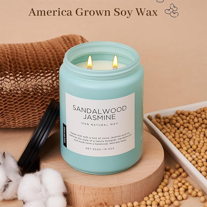 Candle with sandalwood jasmine scent on a wooden stand with cotton and soybeans, labeled '2 Cotton Braid Wicks America Grown Soy Wax'.