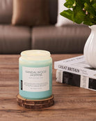 Sandalwood Jasmine candle on a wooden coaster with a blurred background