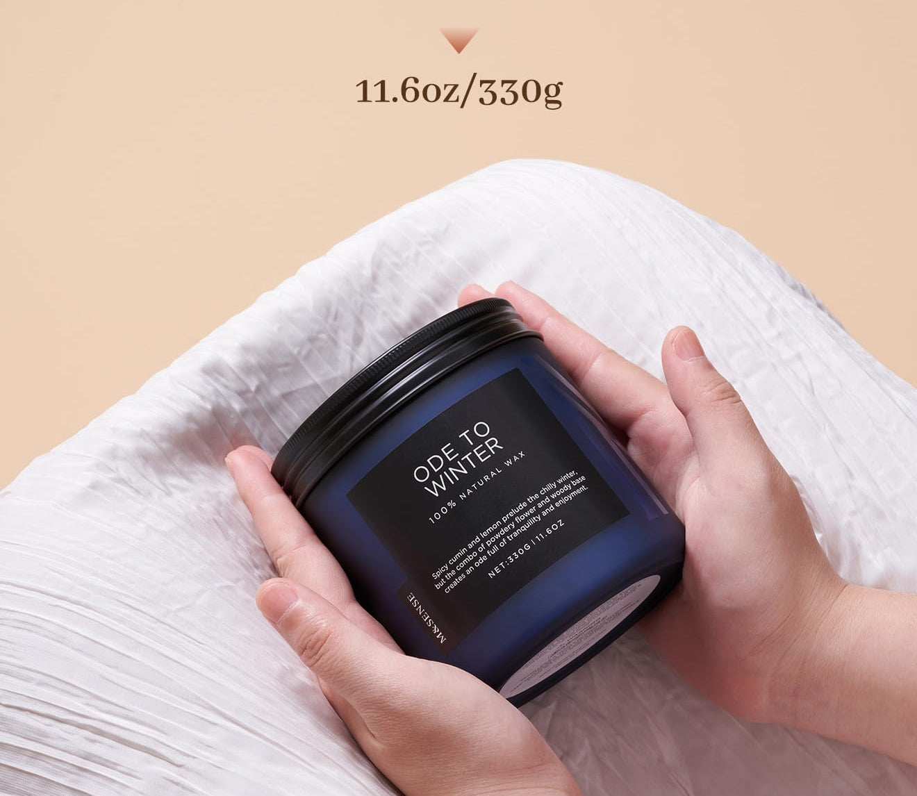 Candle jar held by a hand with 'Burn Time Up to 70 hours' and '11.6oz/330g' text on a beige background.