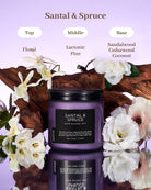 Santal & Spruce candle with floral elements on a reflective surface