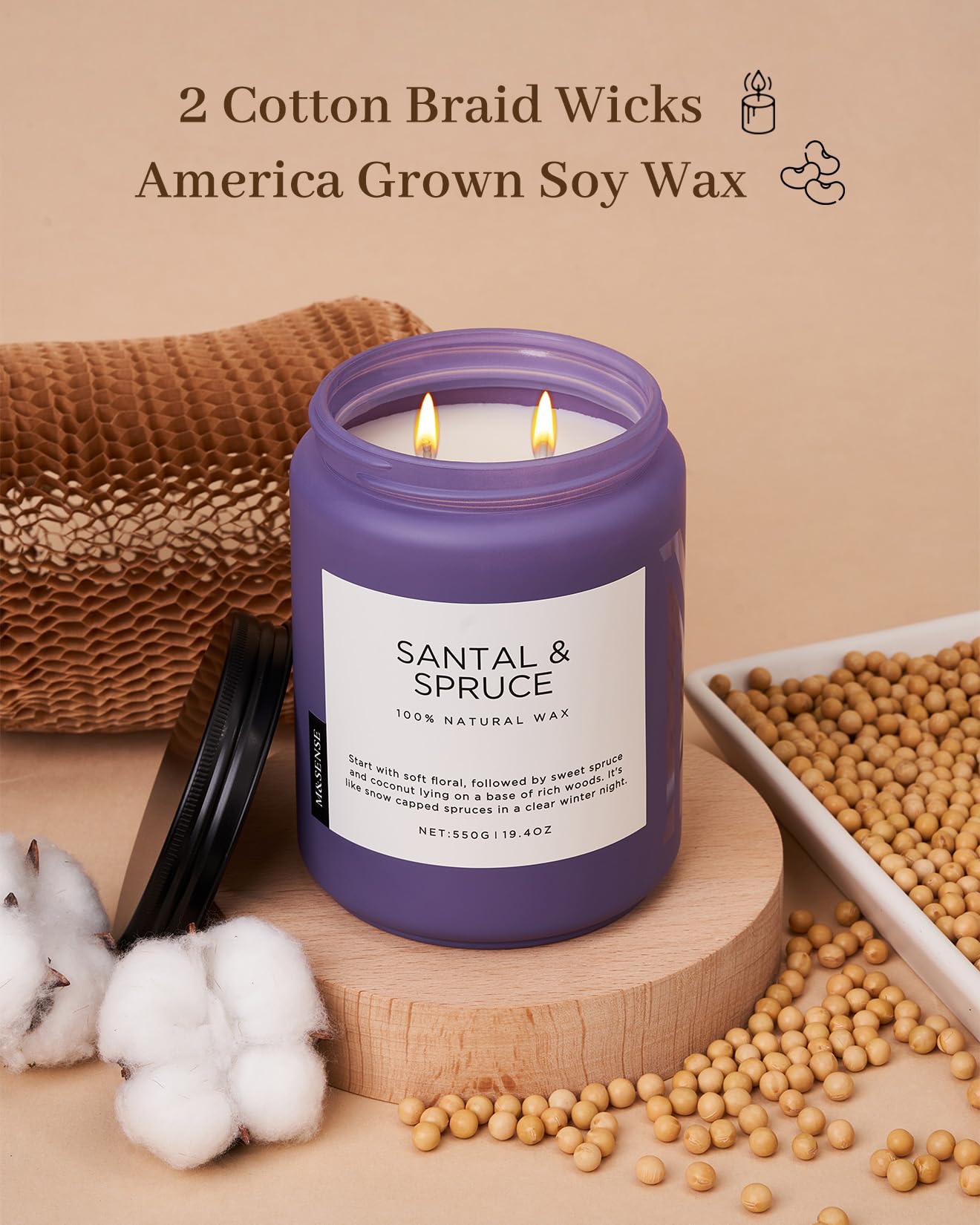 Purple candle labeled 'Santal & Spruce' with cotton braid wicks and soy wax on a wooden surface.