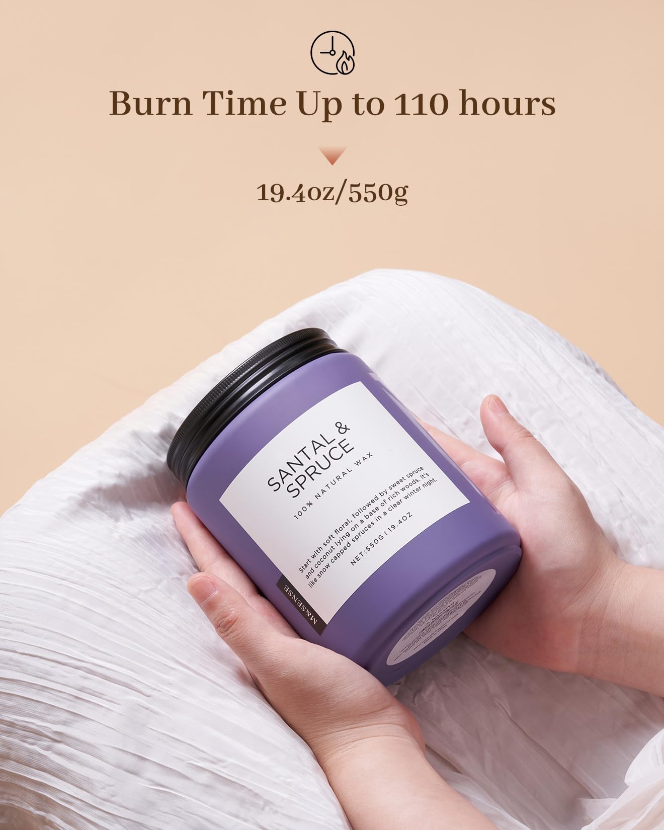 Hand holding a purple candle labeled 'Santal & Spruce' with text about burn time and weight on a beige background.