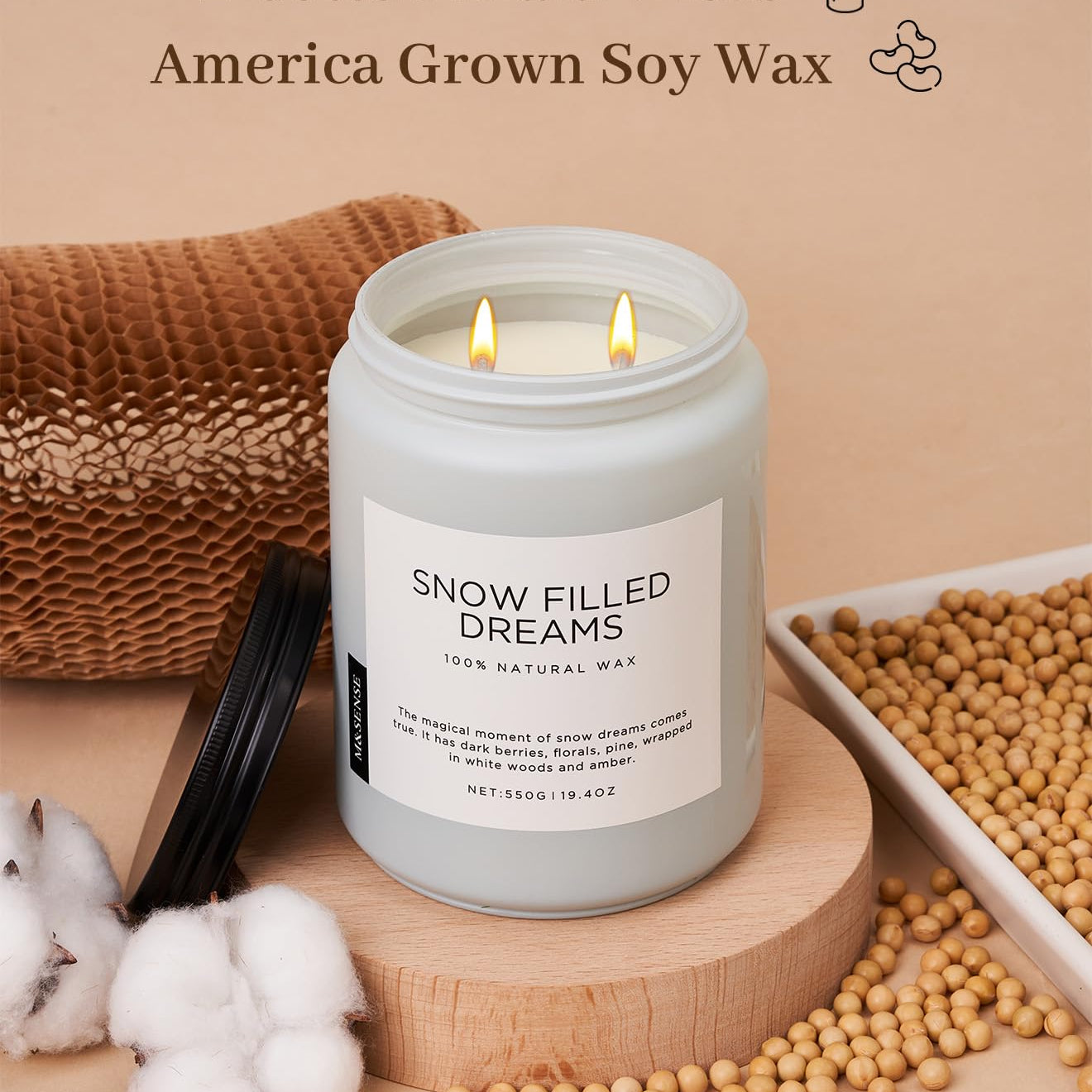 Candle labeled 'Snow Filled Dreams' with cotton braid wicks and soy wax on a beige background