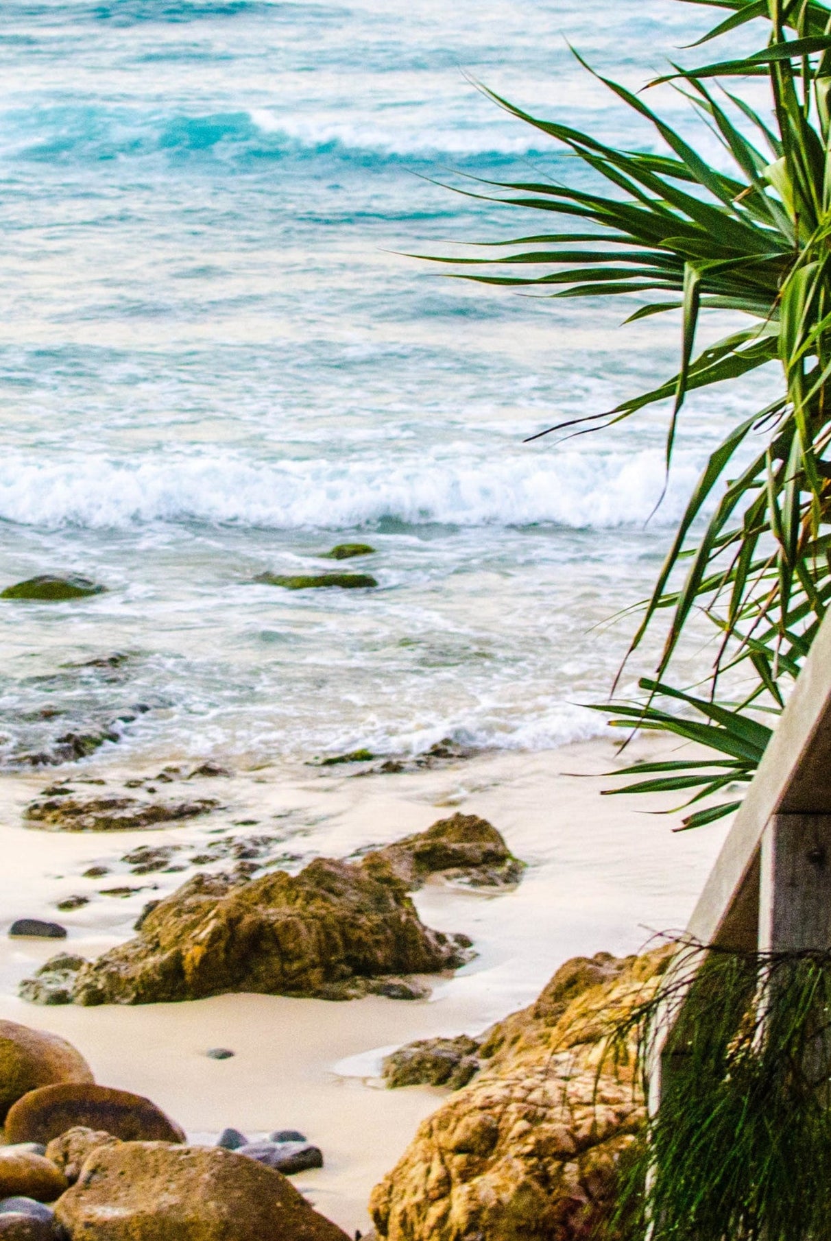 Wooden steps leading to a beach with ocean view