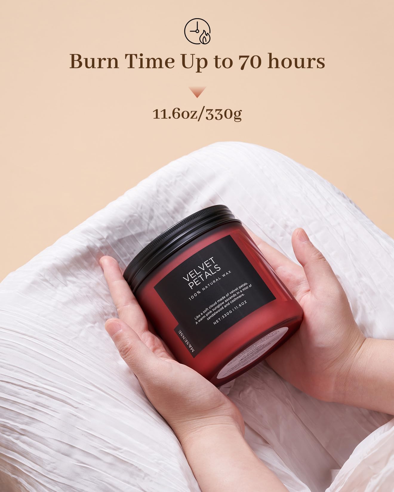Red candle with black lid held by hands on a beige background, featuring text about burn time and weight.
