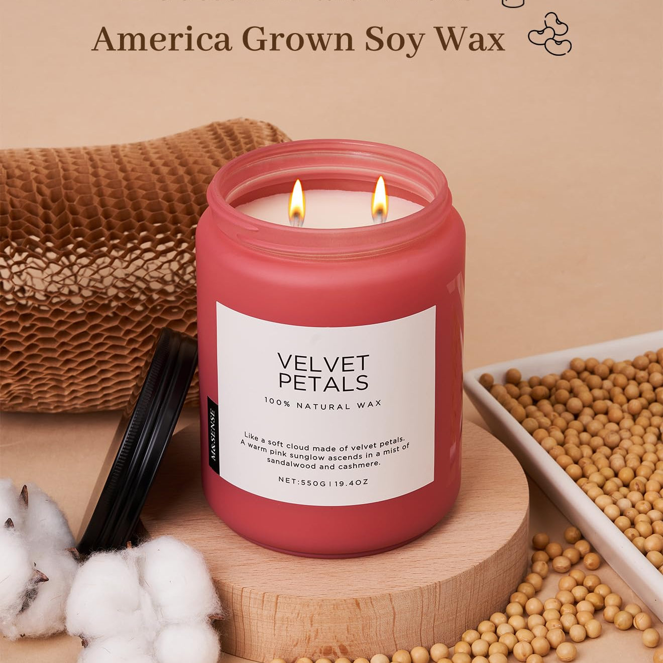 Pink candle labeled 'Velvet Petals' with cotton braid wicks and 'America Grown Soy Wax' text on a beige background.