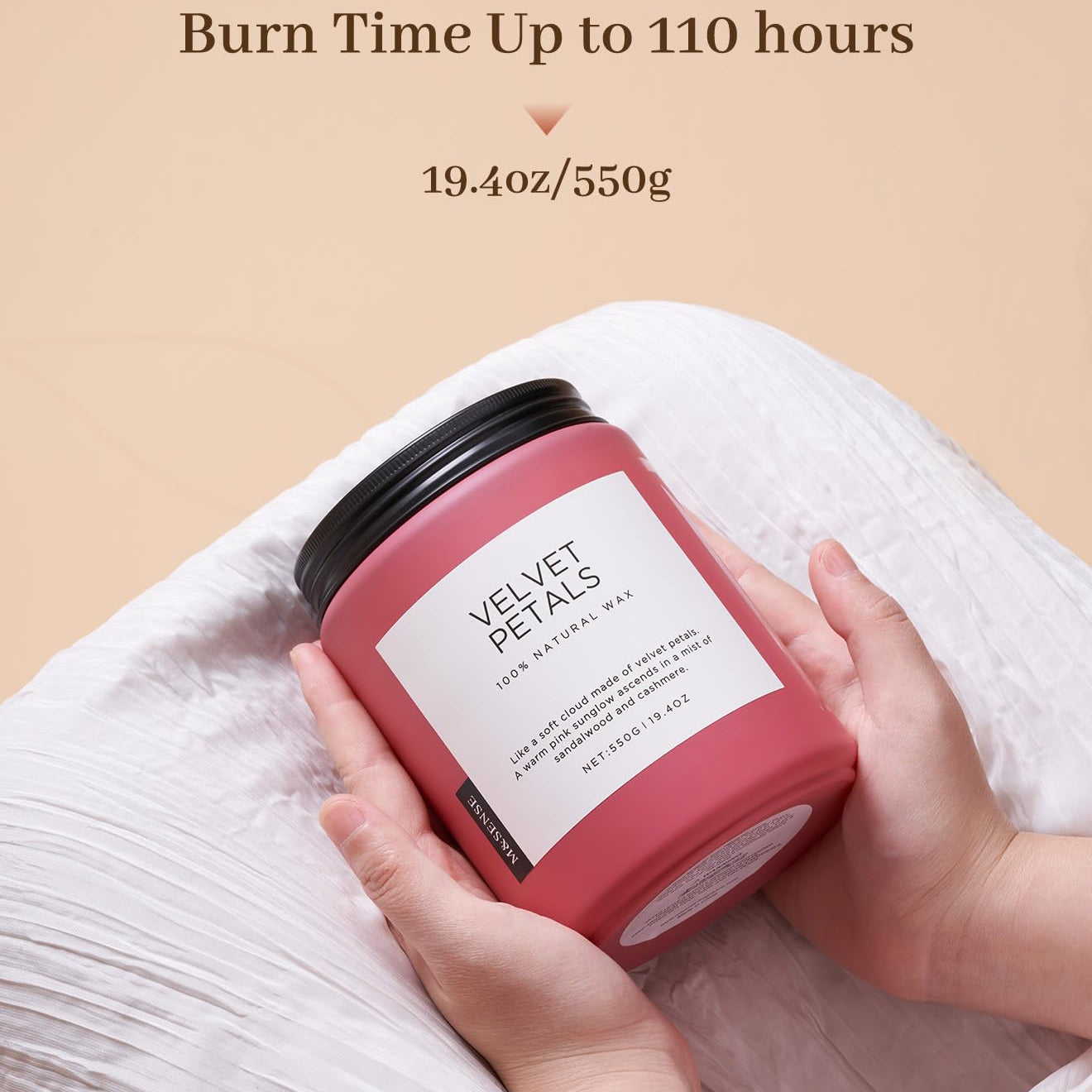 Pink candle labeled 'Velvet Petals' held by a hand with a beige background