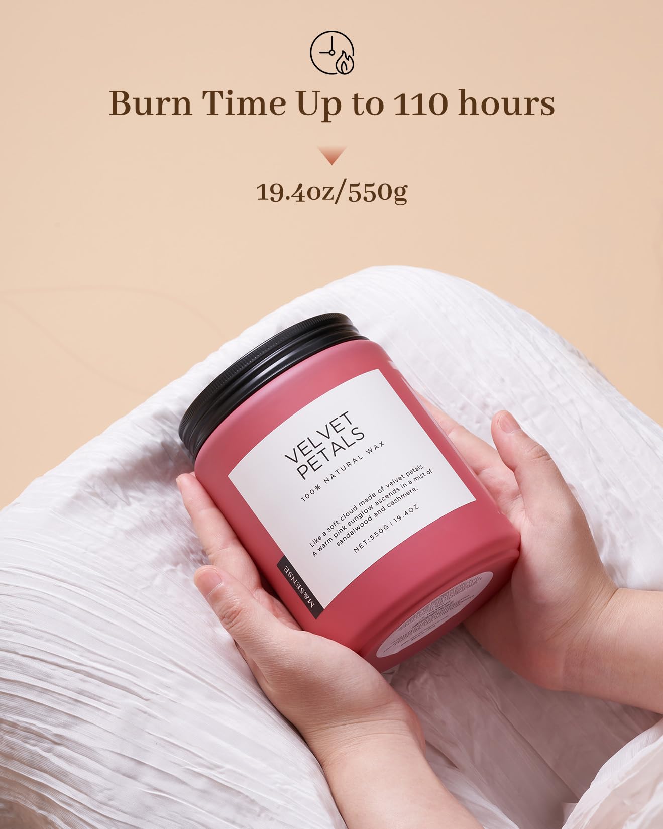 Pink candle labeled 'Velvet Petals' held by a hand with a beige background