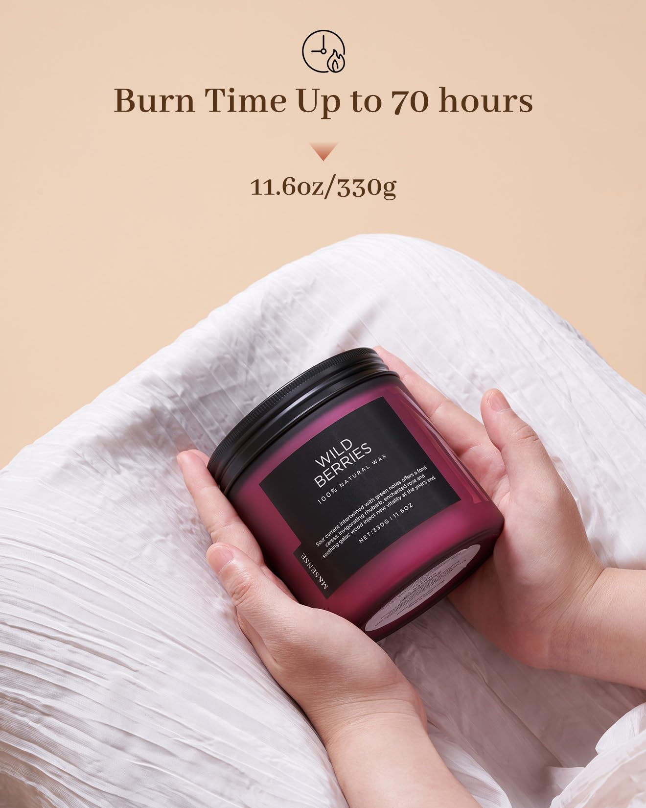 Candle jar held by hands with 'Wild Berries' branding on a beige background