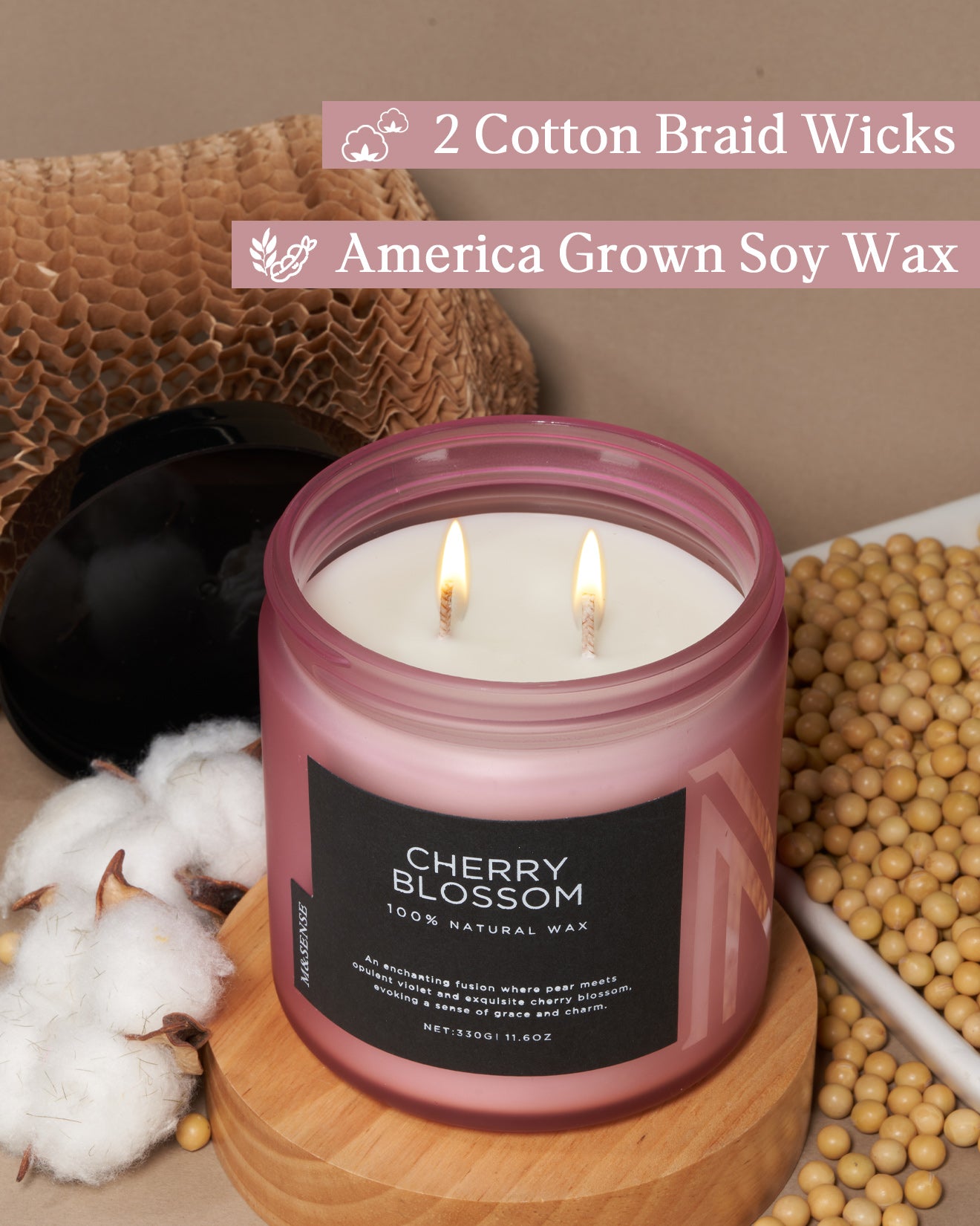 Candle with 'Cherry Blossom' label on a wooden surface with cotton and soybeans, featuring text about wicks and wax.