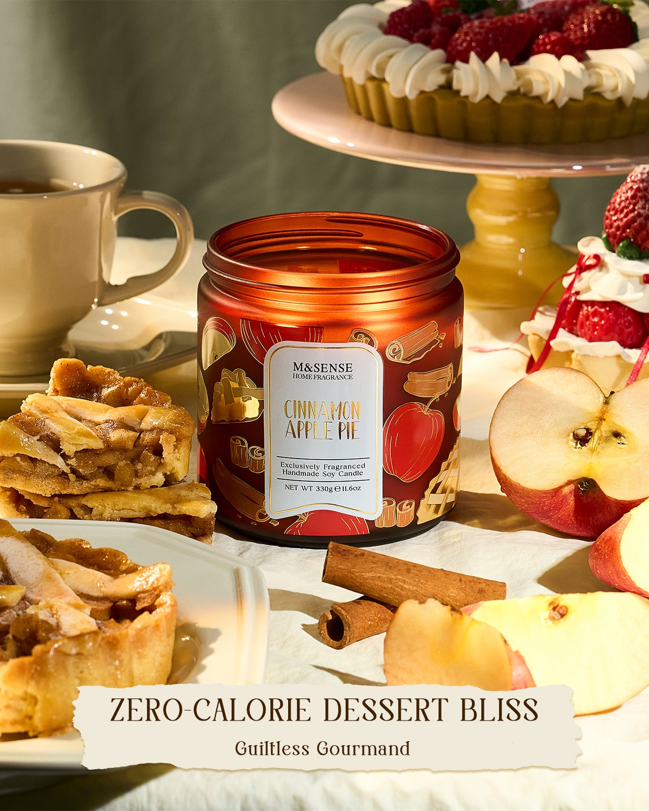 Candle with apple pie design surrounded by apple slices, pies, and a cup on a neutral background