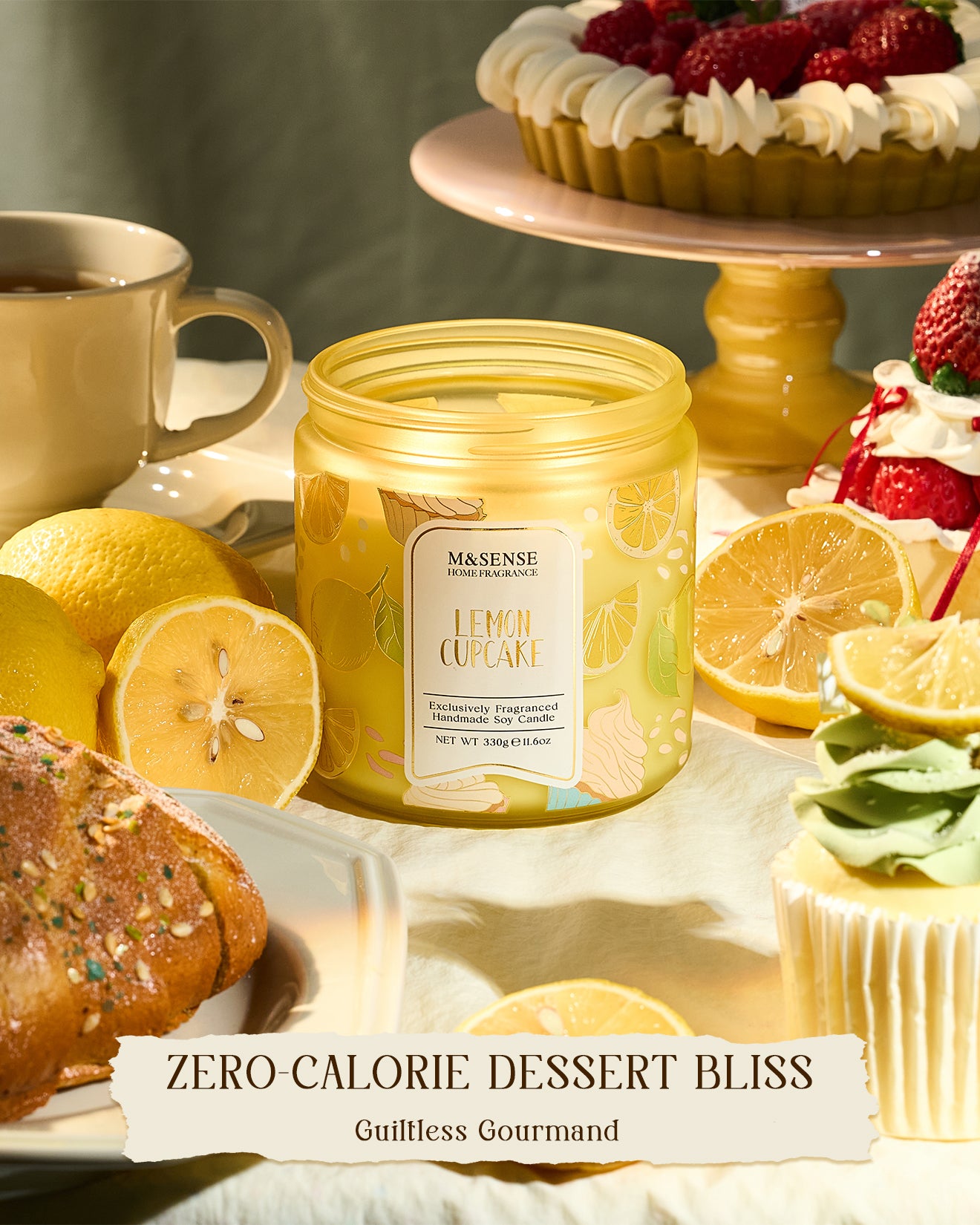 Jar of M&N Sense Lemon Cupcake candle with lemons, cupcakes, and a cake in the background.