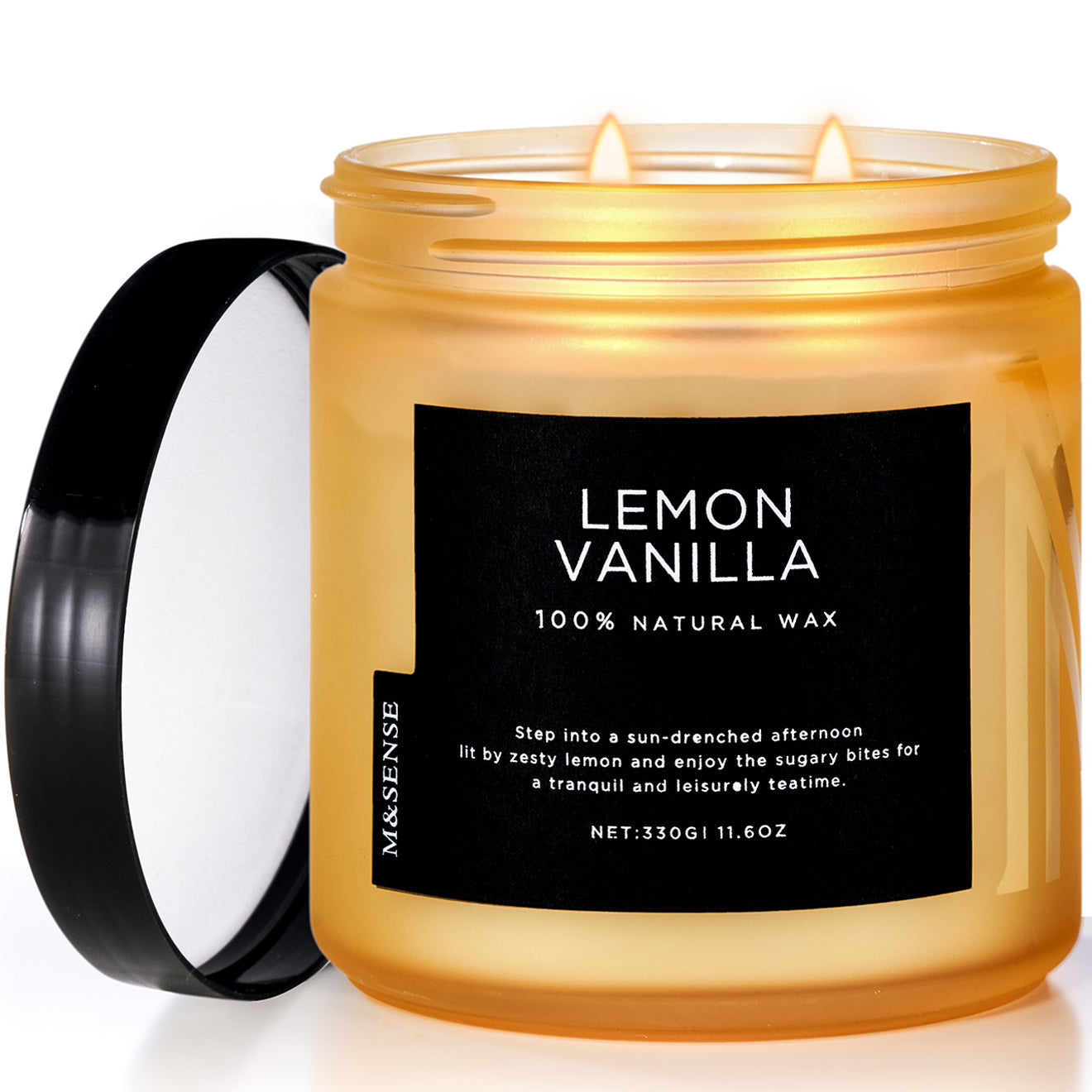 A candle with a black label that reads 'LEMON VANILLA 100% NATURAL WAX' and a black lid, placed on a surface.