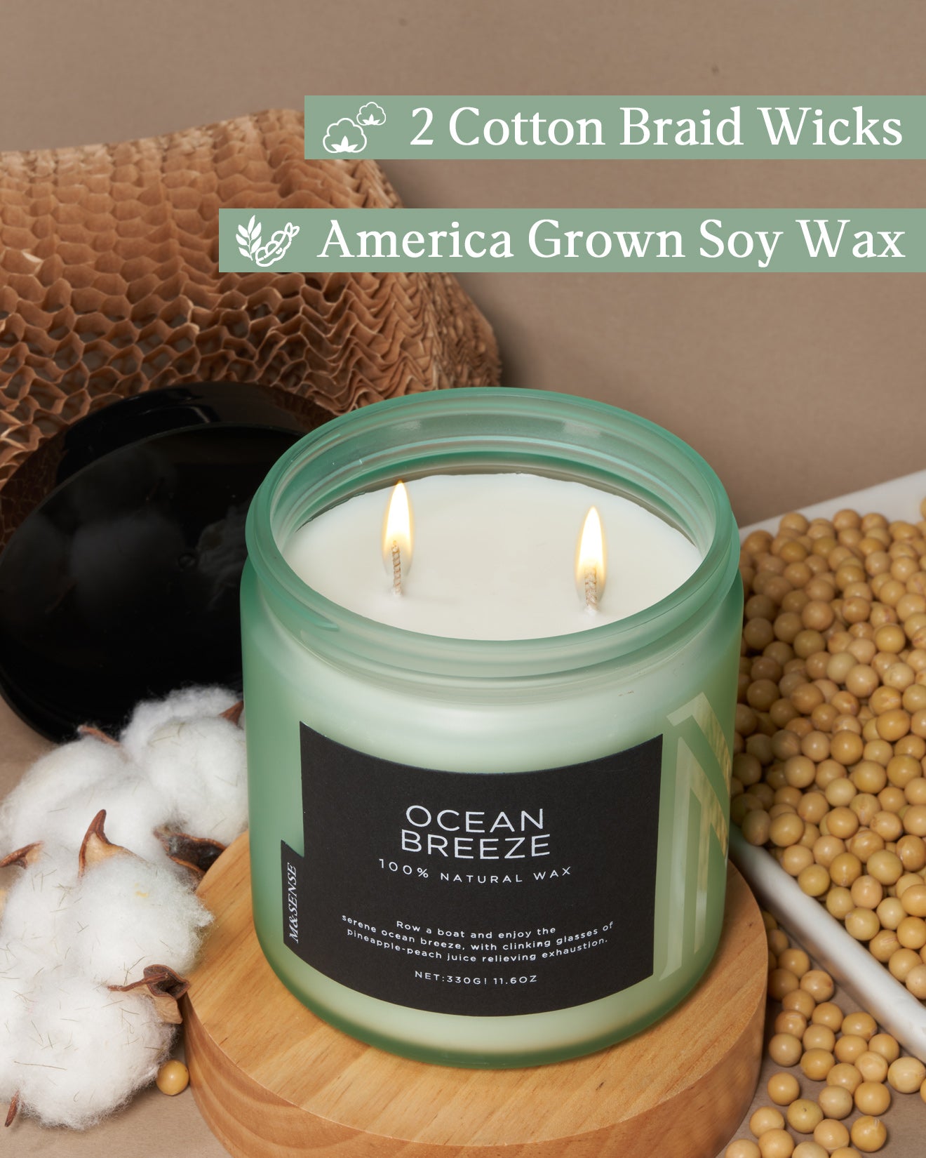 Candle with 'Ocean Breeze' label on a wooden surface with cotton and soybeans, featuring text about wicks and wax.