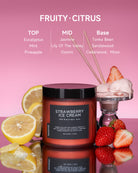 Strawberry Ice Cream candle with fragrance notes, surrounded by fresh strawberries and ice cream.