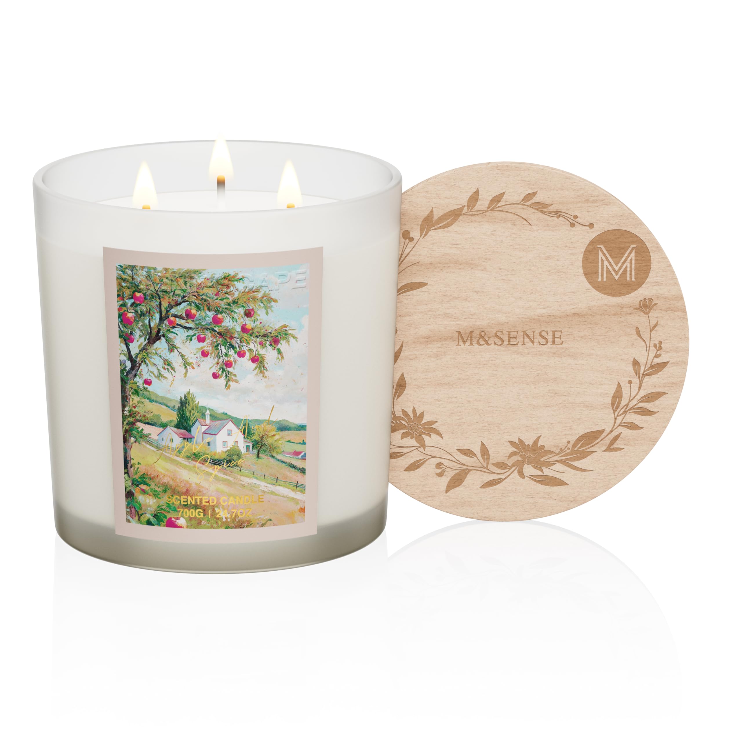 Candle with a scenic label and wooden coaster on a white background