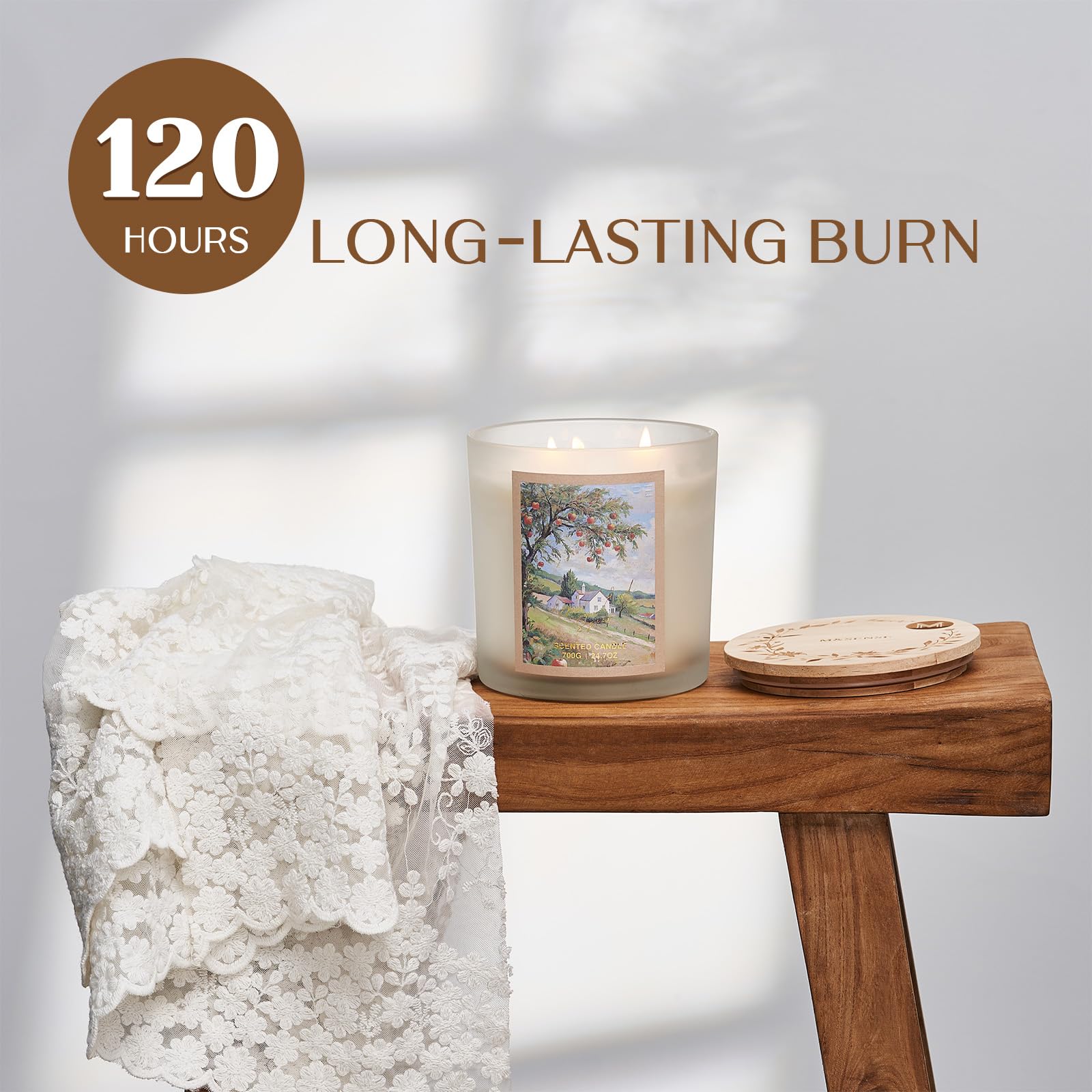 Candle with scenic design on a wooden table, featuring '120 Hours Long-Lasting Burn' text.