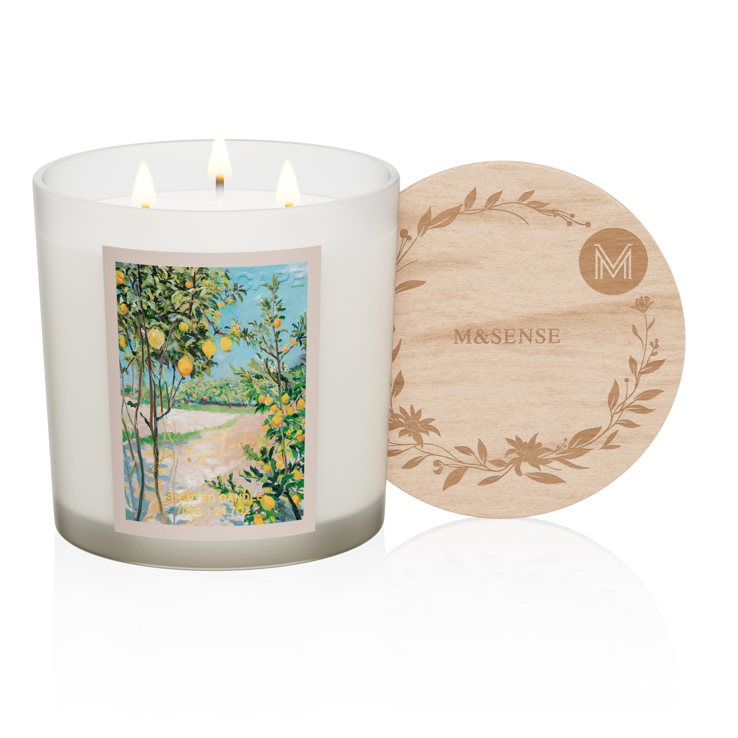 Candle with a scenic label and wooden coaster on a white background