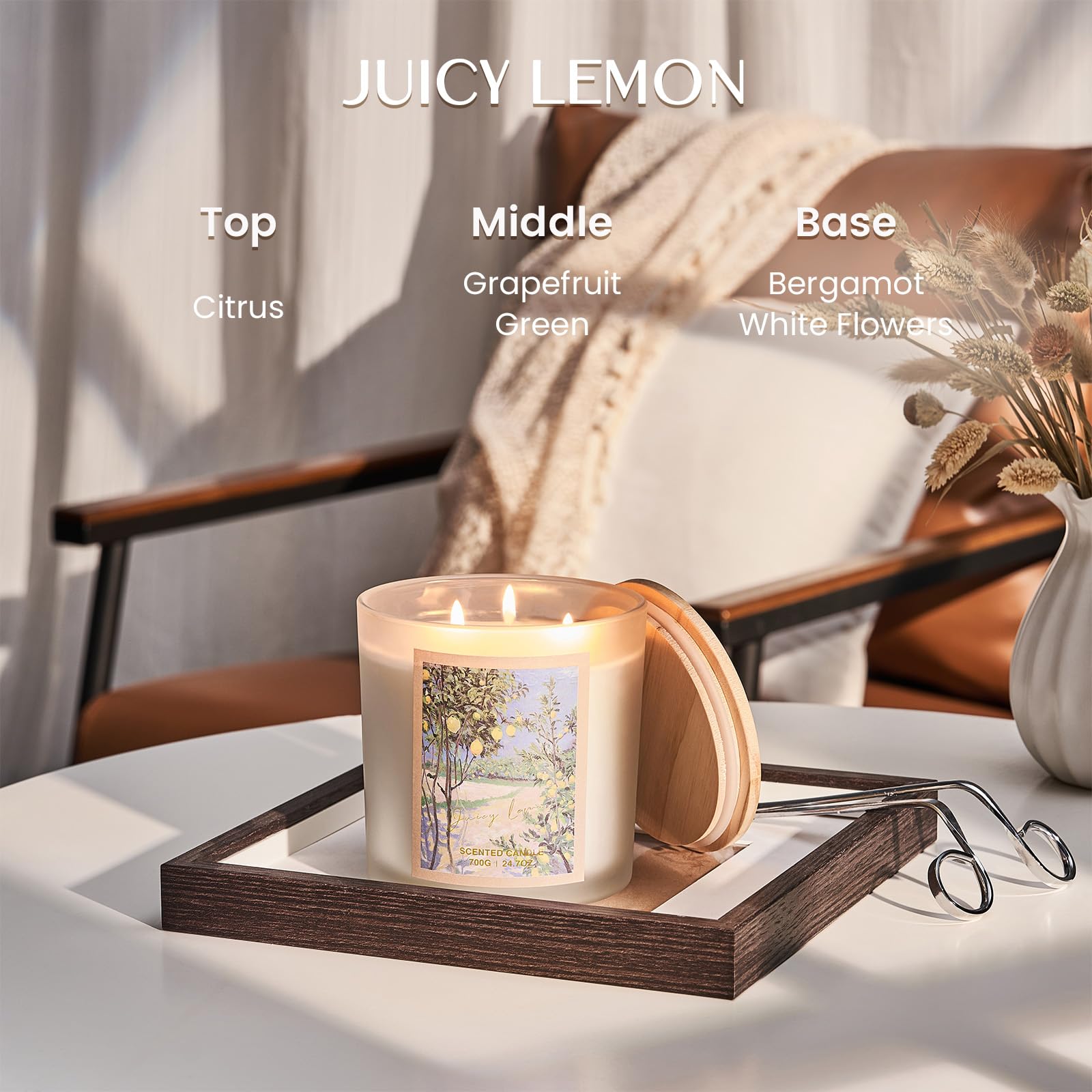 Candle labeled 'Juicy Lemon' with fragrance notes on a table with a blurred background