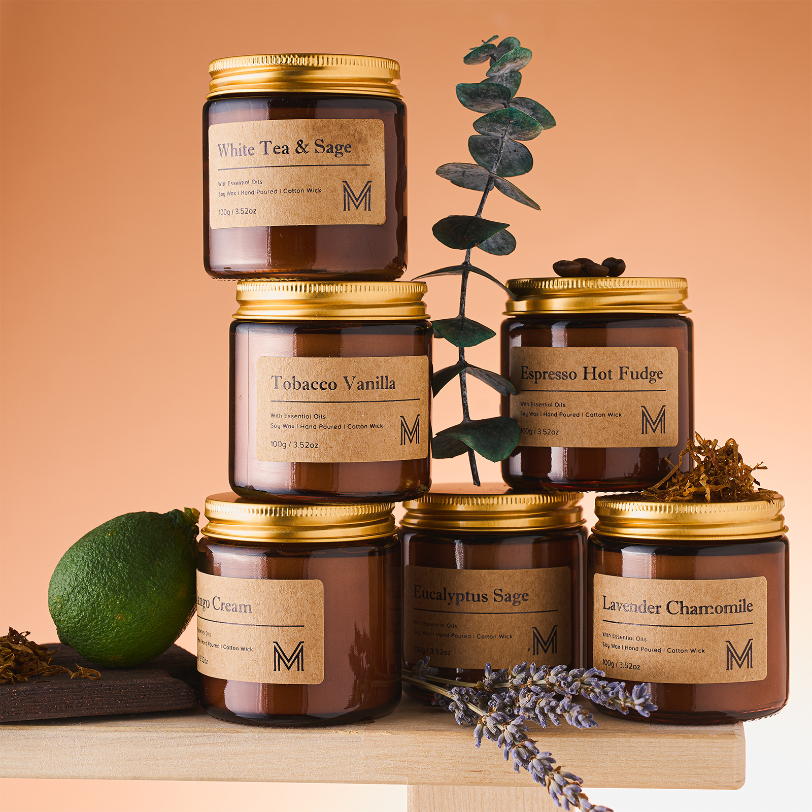 Collection of candles with labels on a wooden surface and beige background