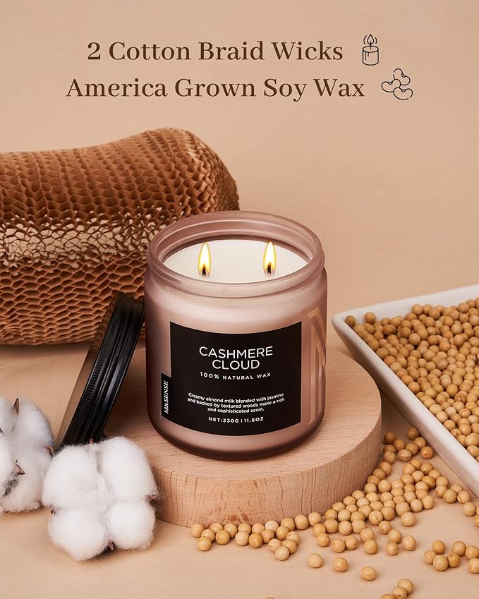 Candle with 'Cashmere Cloud' label on a wooden surface with cotton and soybeans, featuring text about wicks and wax.