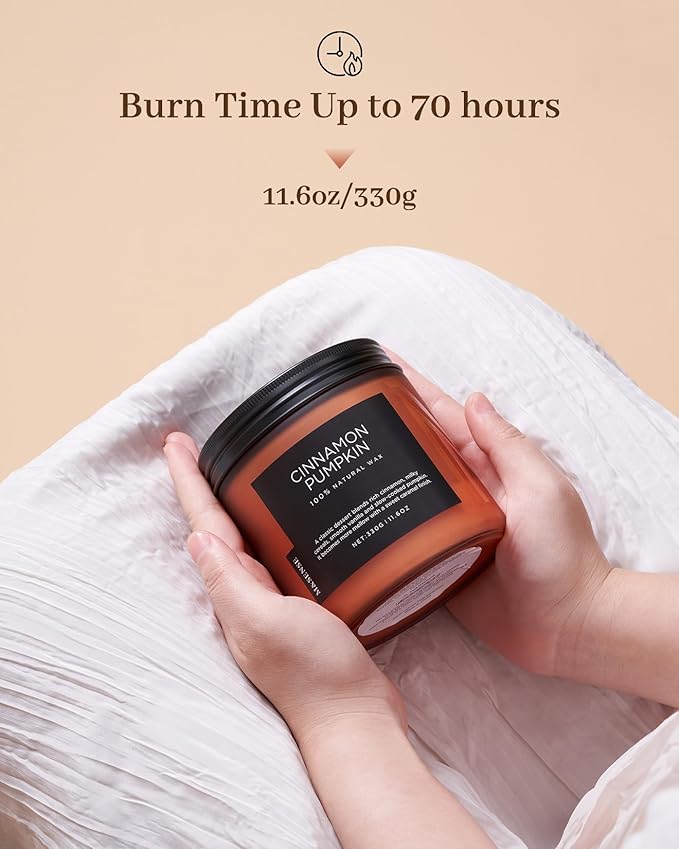Candle jar labeled 'Cinnamon Pumpkin' held by hands with text indicating burn time and weight.